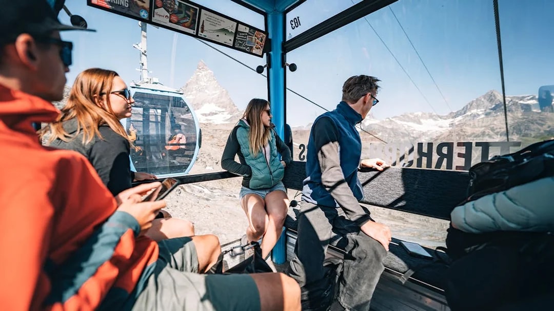 Tourists inside cable car with view of Matterhorn Glacier in Switzerland.