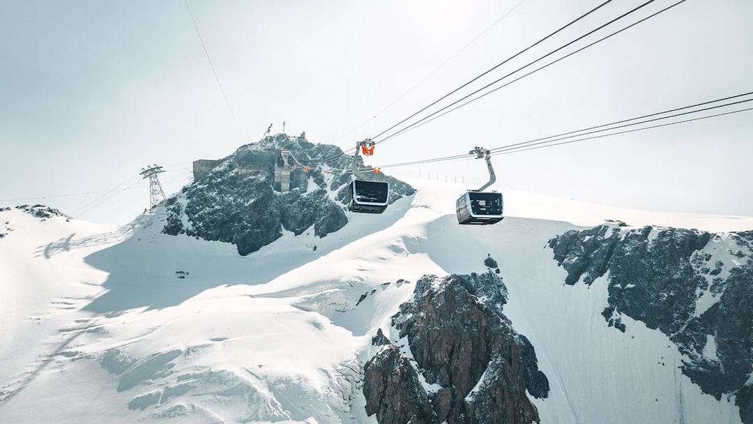 Cable car ascending Matterhorn Glacier Paradise with snowy peaks.