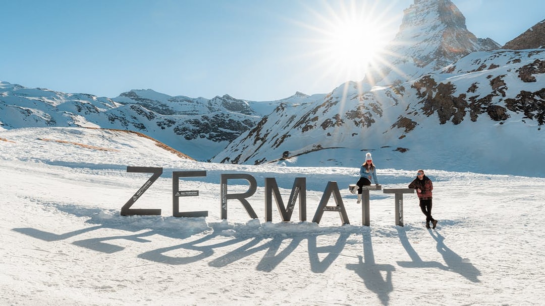 Tourists at Zermatt mountain top with Matterhorn in background.