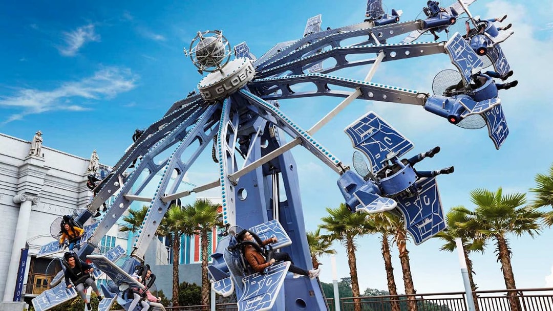 Visitors enjoying a thrilling ride at Skyworld Theme Park.