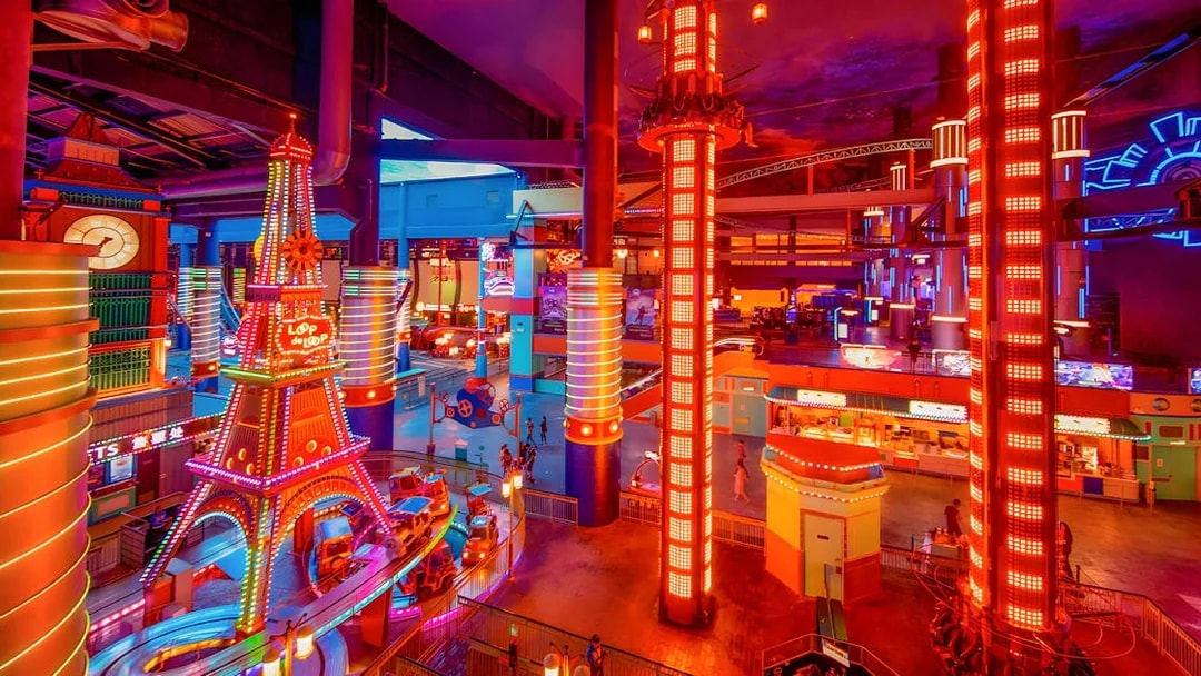 Genting Skytropolis Indoor Theme Park with vibrant neon lights and colorful rides.