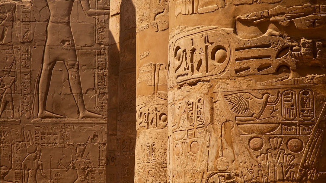 Intricate hieroglyphs on temple columns in Egypt.