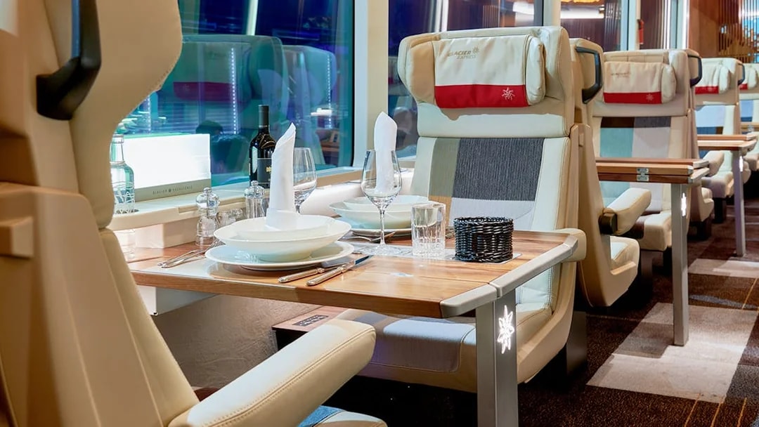 Luxurious dining setup inside Glacier Express train, Switzerland.