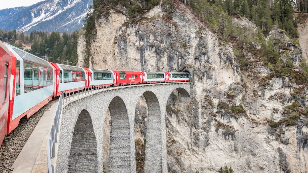 Train crossing Landwasser Viaduct in Swiss Alps.