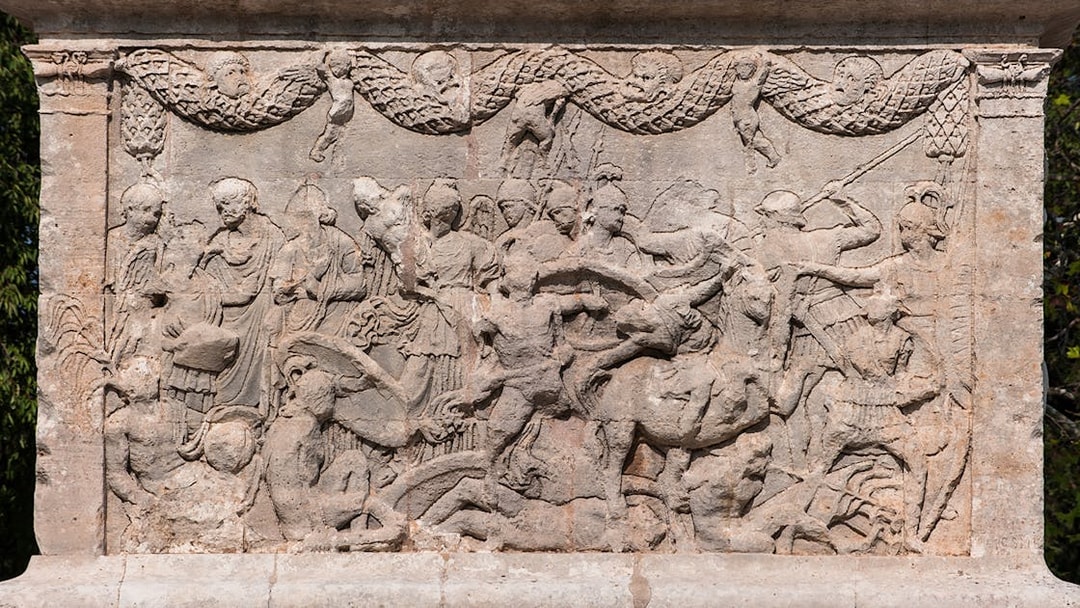 Sculptures depicting historical scenes at Glanum Archaeological Site, France.