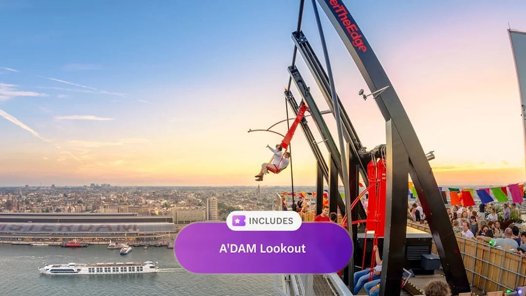ADAM Lookout swing with Amsterdam cityscape at sunset.