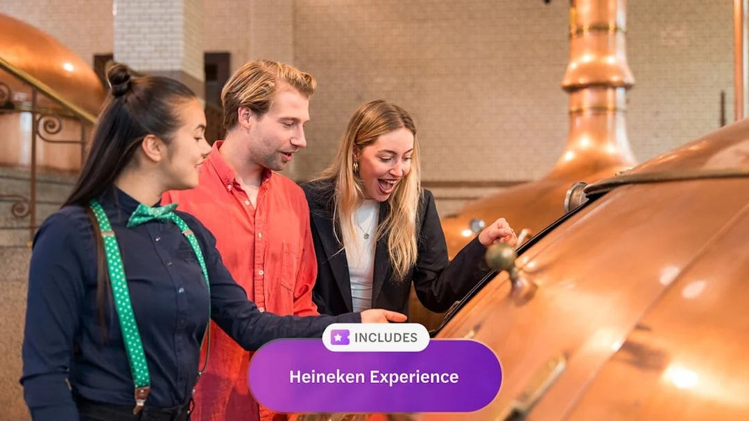 Visitors exploring brewing equipment at Heineken Experience, Amsterdam.