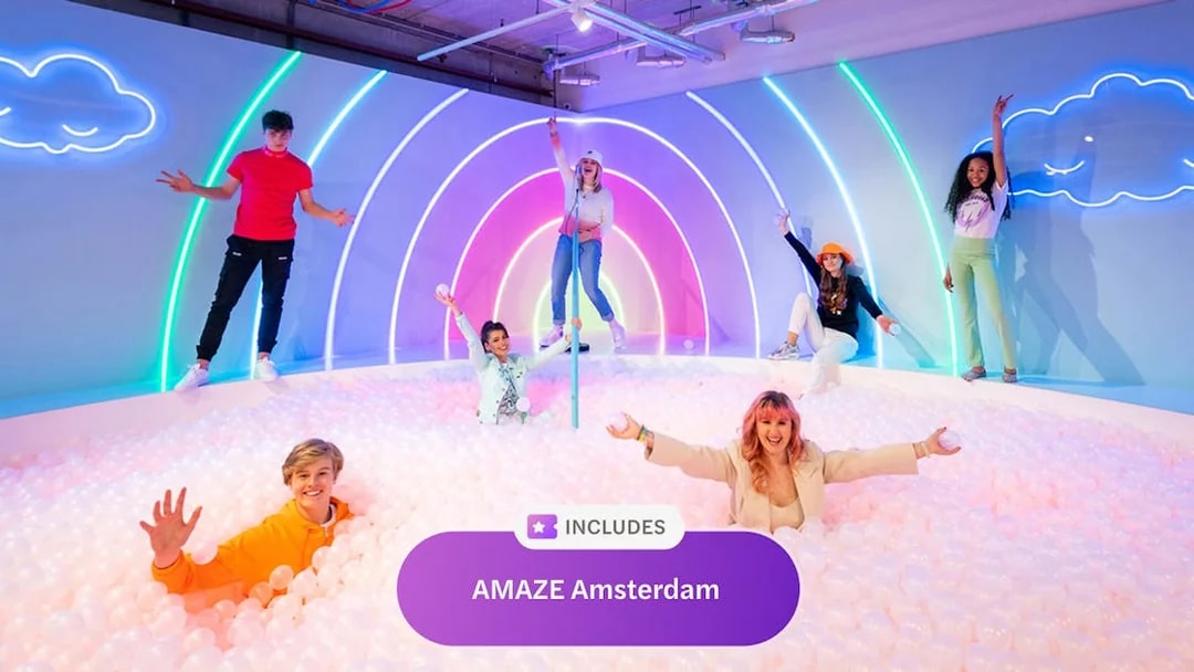 Visitors enjoying a colorful ball pit at AMAZE Amsterdam, part of Go City Amsterdam Explorer Pass.
