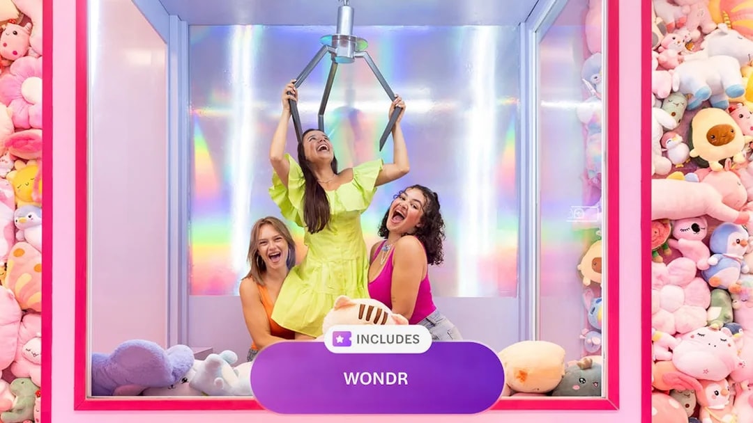 Women enjoying a claw machine experience at WONDR Amsterdam.