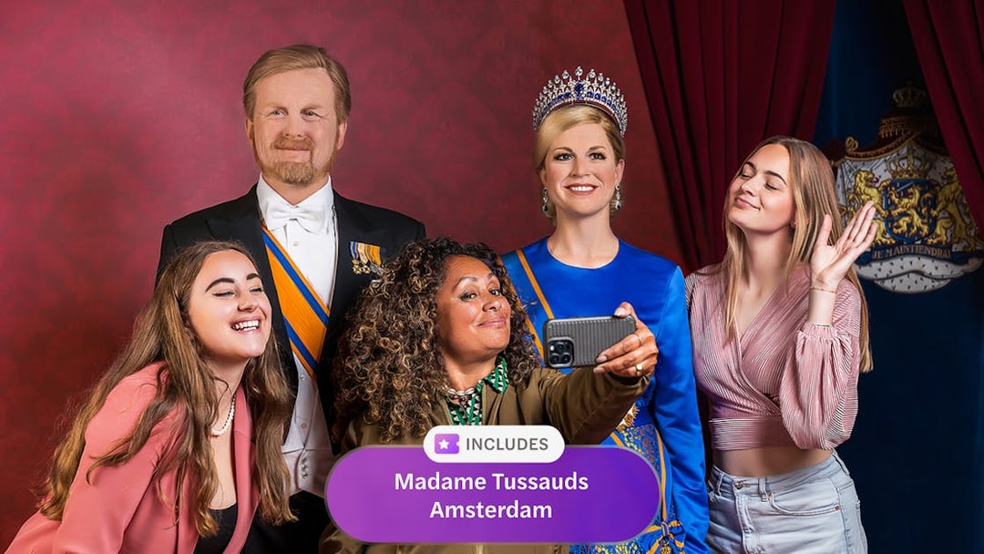 Visitors taking a selfie with wax figures at Madame Tussauds Amsterdam.