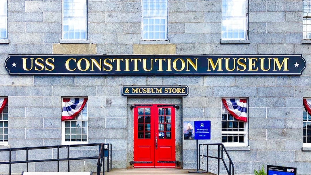 USS Constitution Museum entrance with red doors and patriotic bunting.