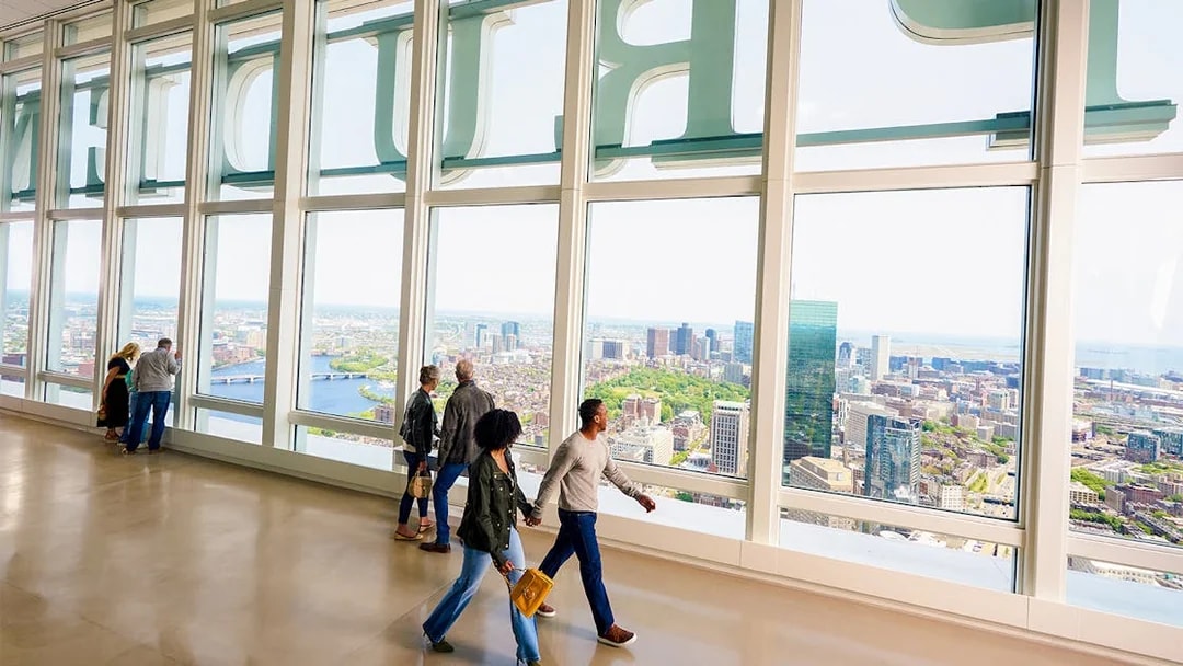 People enjoying city views from View Boston observation floor.