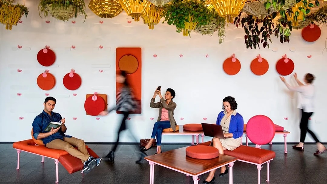 People relaxing and working in a modern lounge with colorful decor in Chicago.