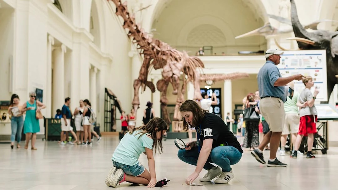 Children exploring dinosaur exhibit at Chicago's Field Museum.