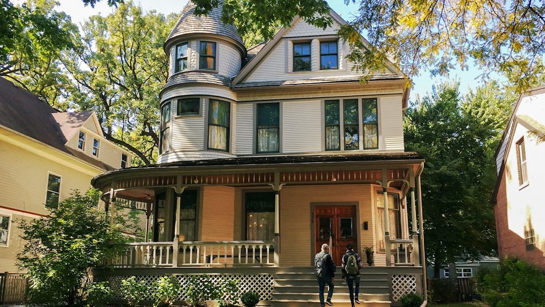 Victorian house in Chicago with two people approaching the entrance.