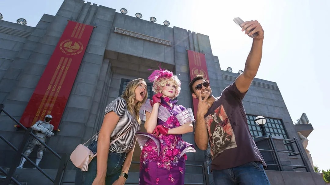Tourists taking a selfie with a character at the Hunger Games ride, Motiongate Dubai.