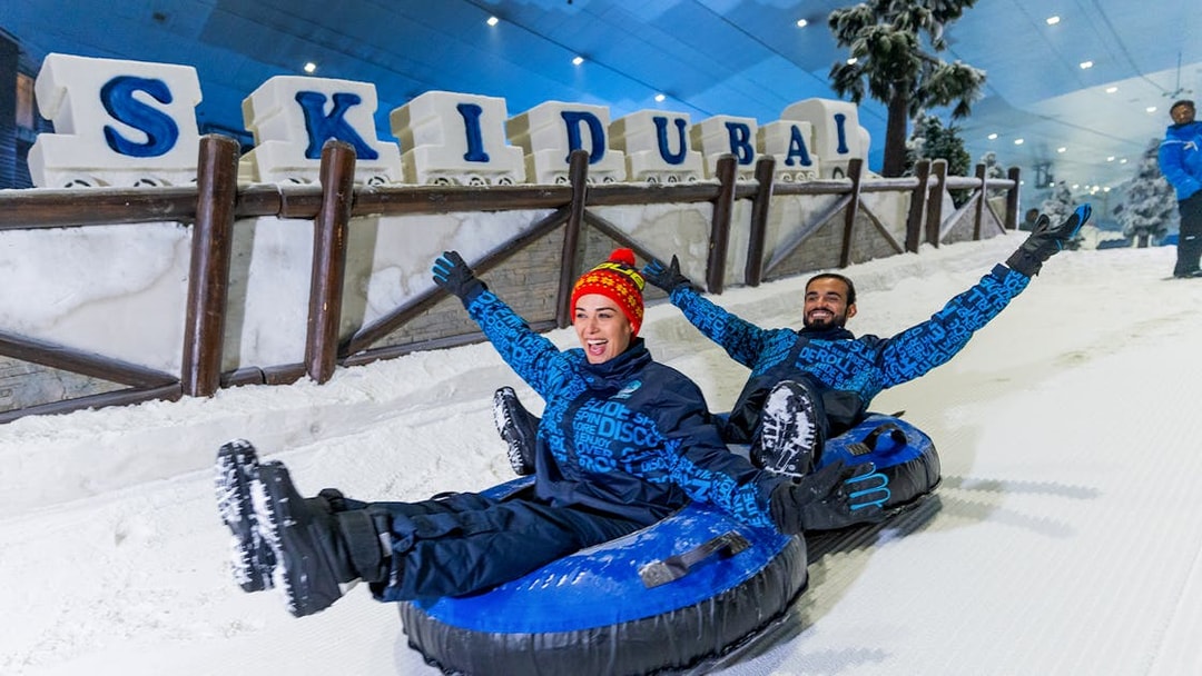 Visitors tubing at Ski Dubai indoor snow park, Dubai, UAE.