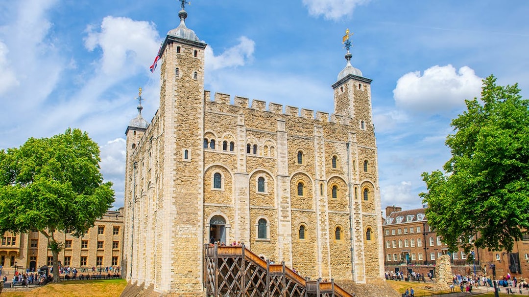 Tower of London with tourists exploring the grounds, London.