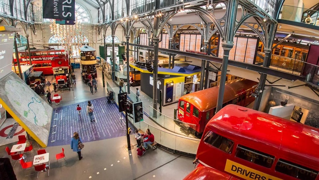 London Transport Museum exhibit with vintage underground train and double-decker buses.
