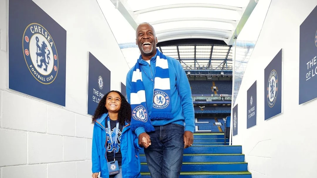 Father and daughter at Chelsea FC stadium entrance, London Explorer Pass.