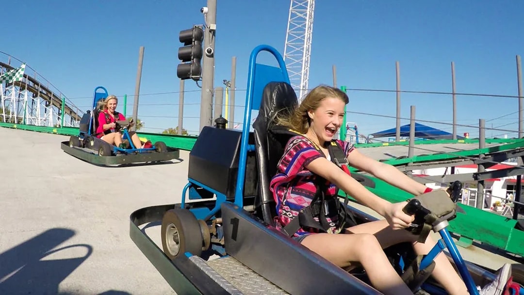 Young girl driving a go-kart at Fun Spot America.
