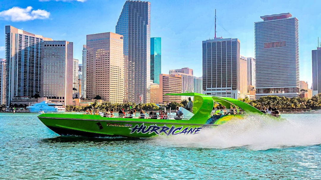 Speedboat named Hurricane cruising past Miami skyline.
