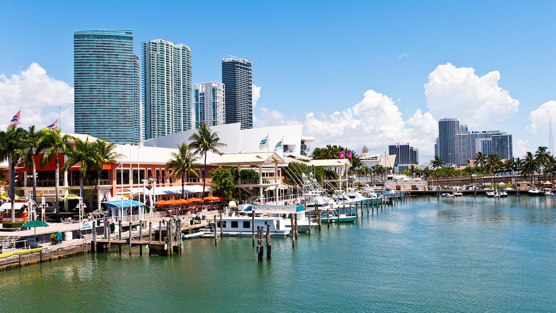 Bayside Marketplace marina with boats and Miami skyline in the background.
