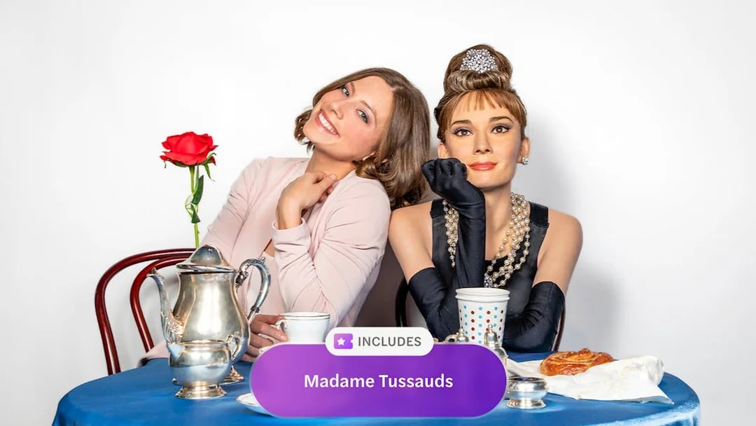 Madame Tussauds New York wax figure with visitor at a tea table.