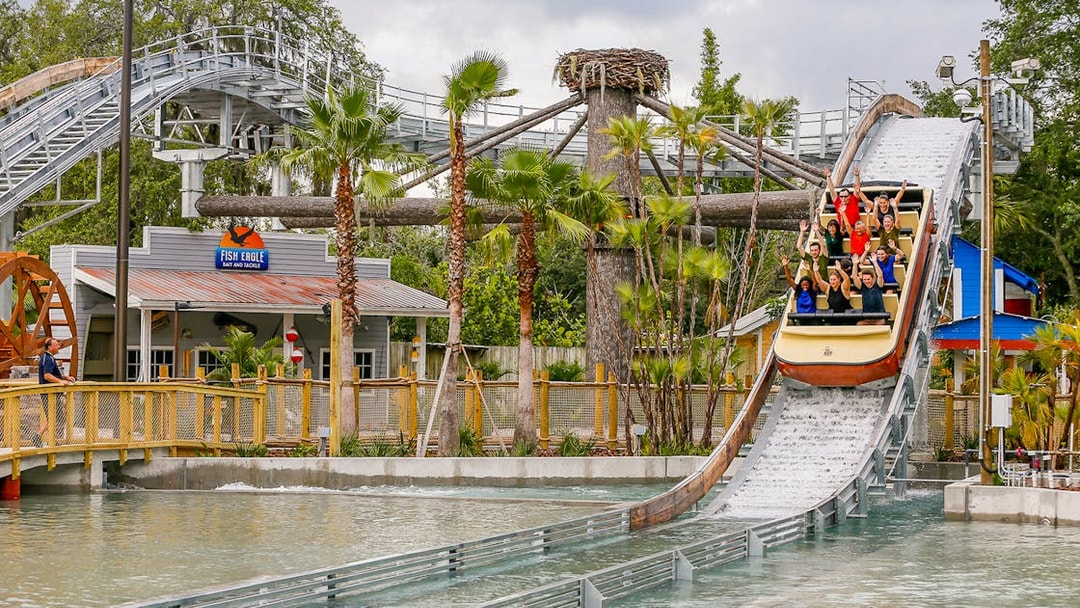 People enjoying a log flume ride at an Orlando theme park, part of the Orlando Explorer Pass.