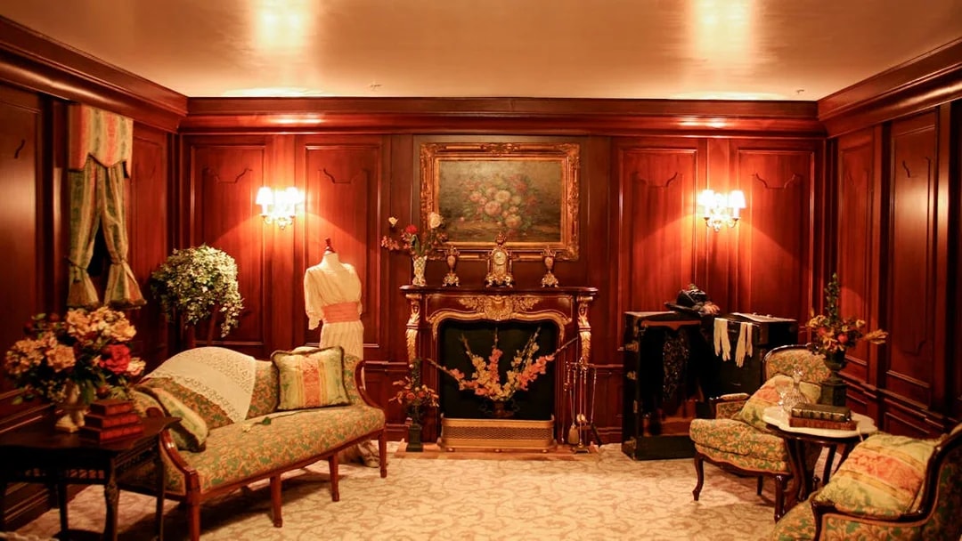Elegant Victorian-style room with ornate fireplace and vintage furniture, part of Orlando Explorer Pass experience.