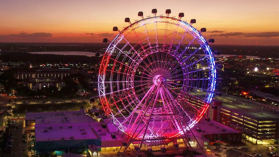 Orlando Ferris wheel lit up at sunset, part of the Orlando Explorer Pass by Go City.
