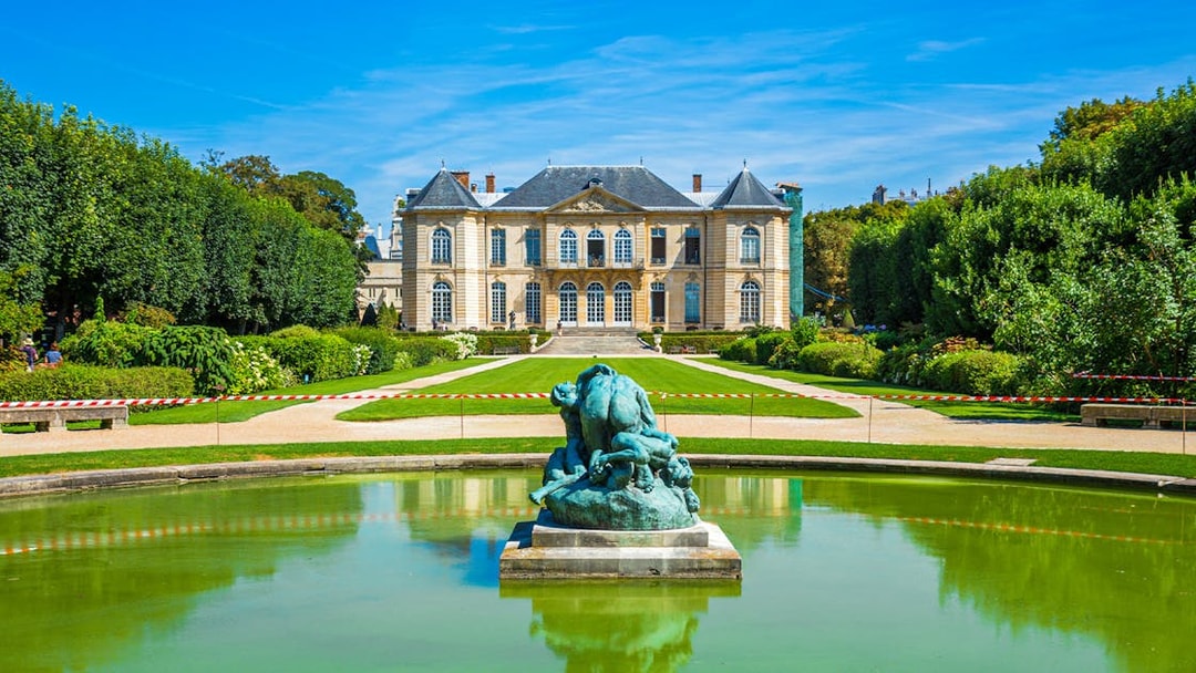 Rodin Museum gardens with sculpture and historic building in Paris.