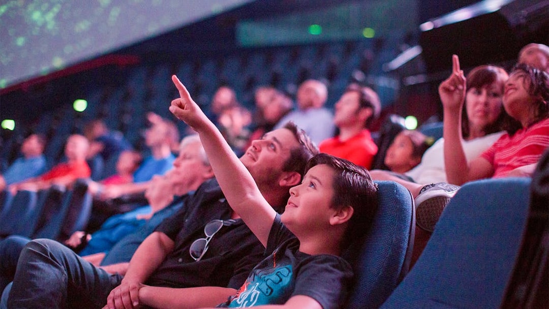 Visitors enjoying a planetarium show in San Diego, part of the Go San Diego Card experience.