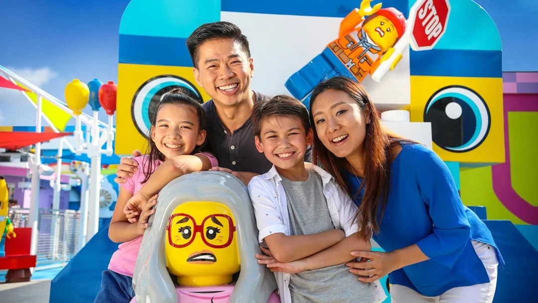 Family enjoying Legoland California with colorful Lego figures, included in San Diego All-Inclusive Pass.