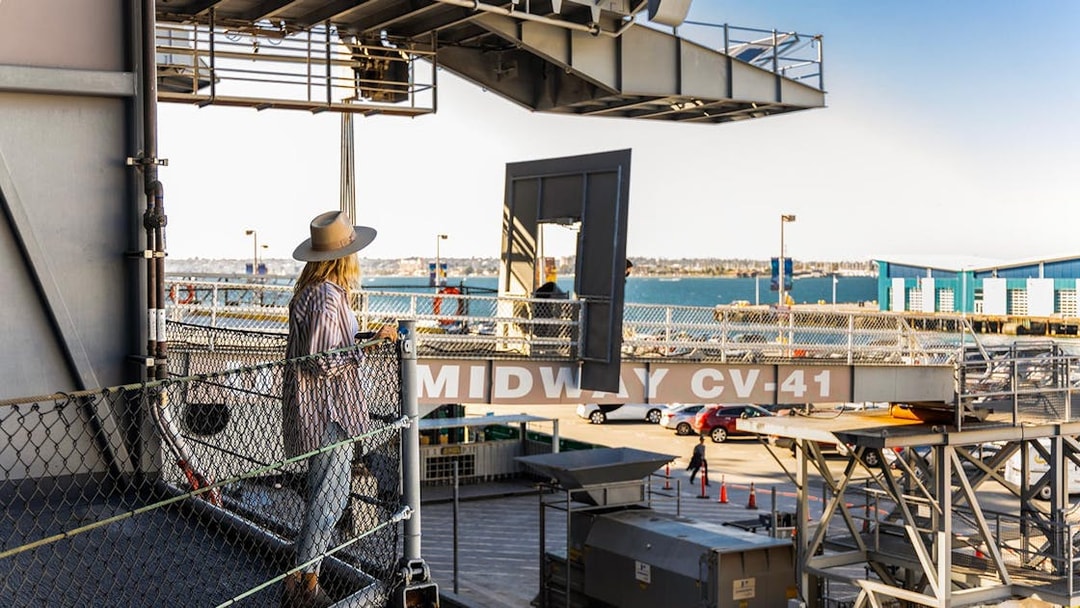 Visitor on USS Midway Museum deck overlooking San Diego Bay.