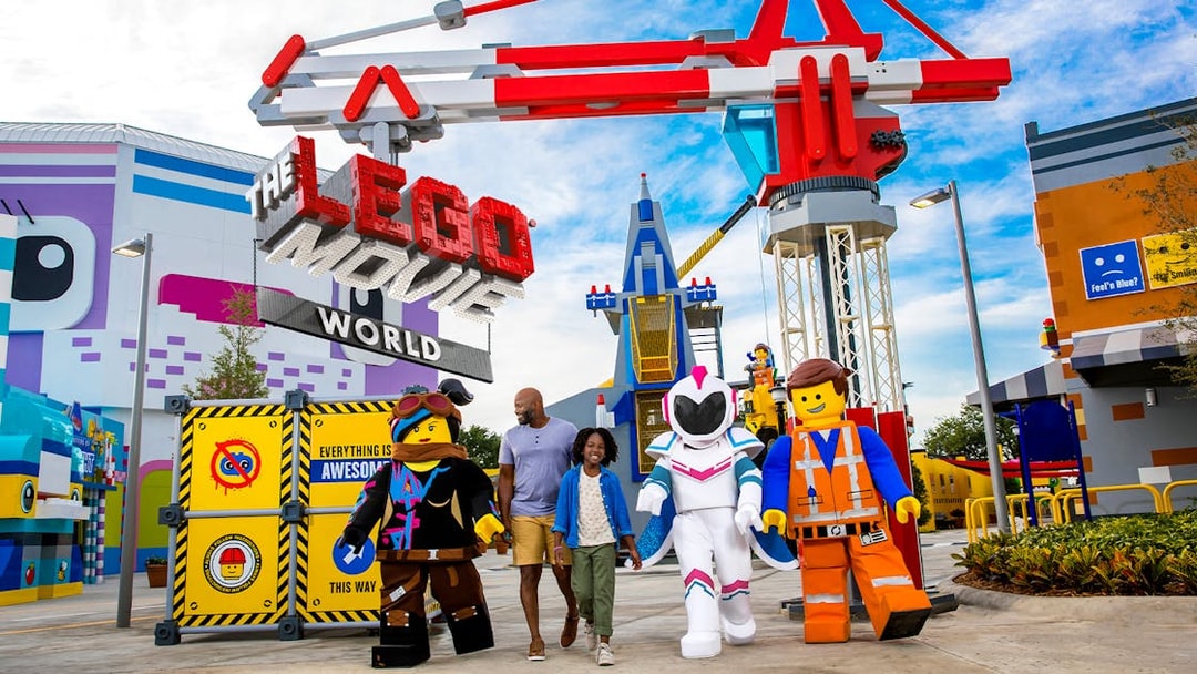 Family walking with LEGO characters at The LEGO Movie World in San Diego.