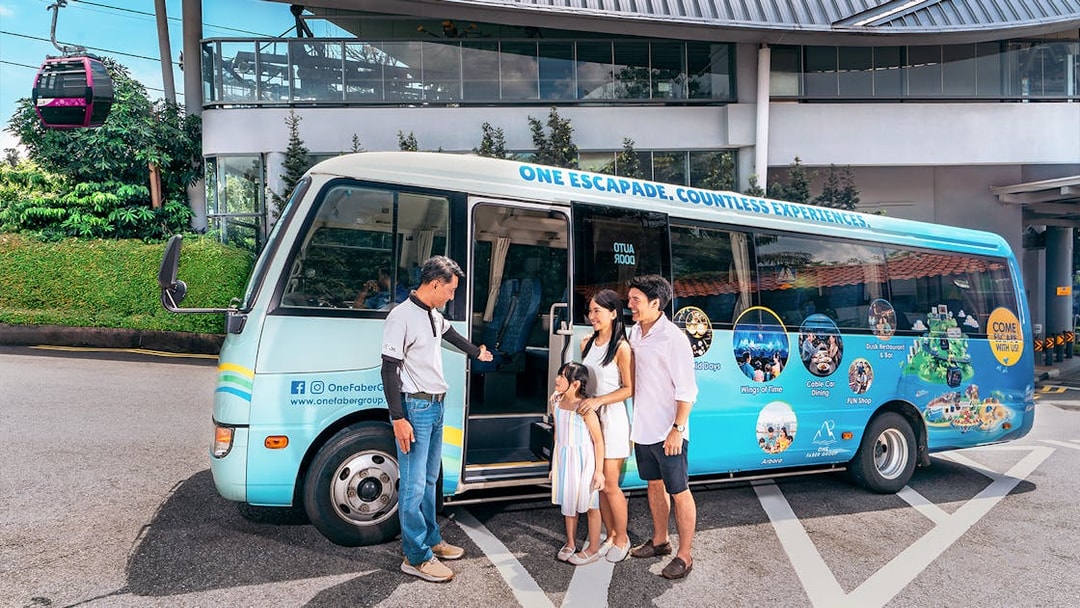 Family boarding tour bus at Singapore cable car station.