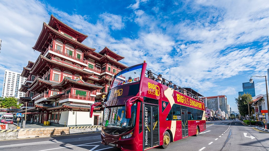 Open-top tour bus near Buddha Tooth Relic Temple, Singapore.