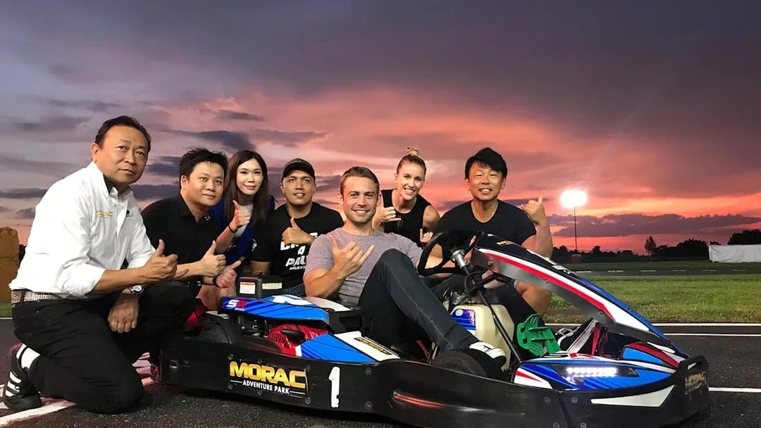 Group enjoying go-karting at Morac Adventure Park, Langkawi, during sunset.
