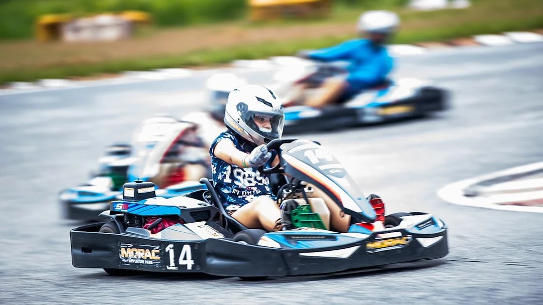 Go-kart racing at Morac Adventure Park, Langkawi, with drivers navigating the track.