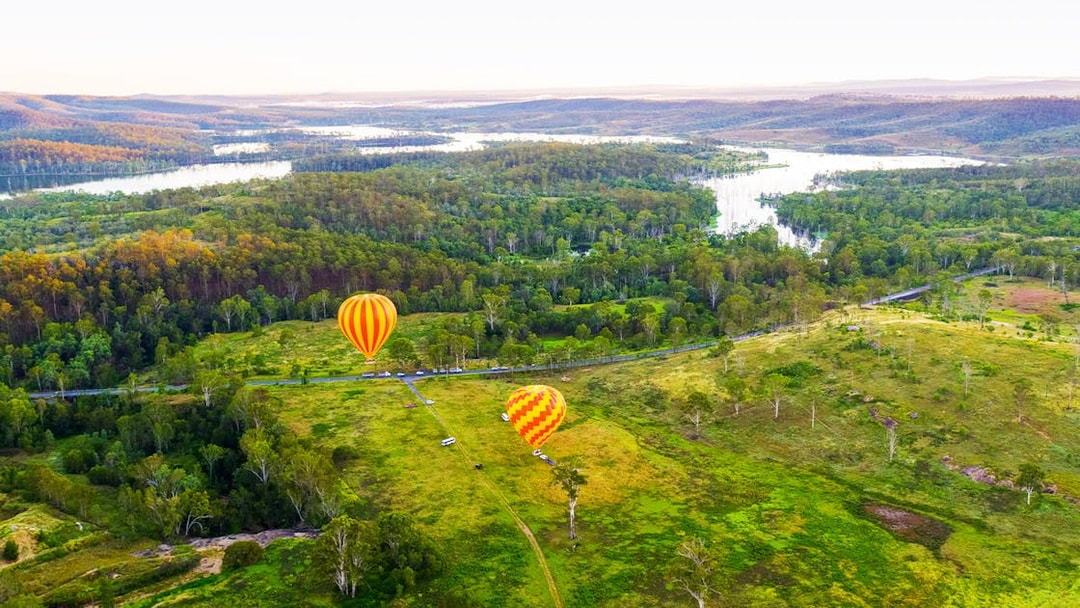 Hot air balloons over lush landscape, Gold Coast, Australia.