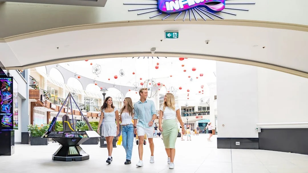 Visitors entering Infinity Attraction at Gold Coast shopping center.
