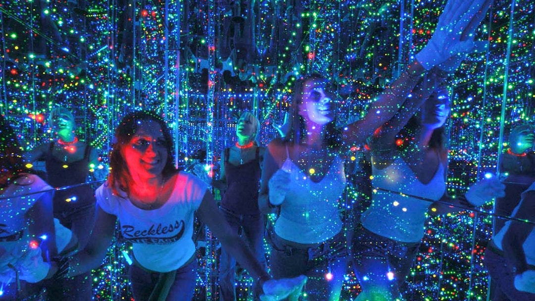 Visitors exploring the mirrored light maze at Infinity Attraction, Gold Coast.
