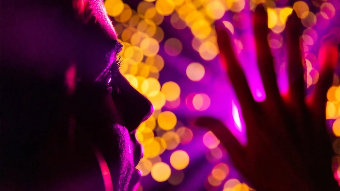Person experiencing vibrant light display at Infinity Attraction, Gold Coast.