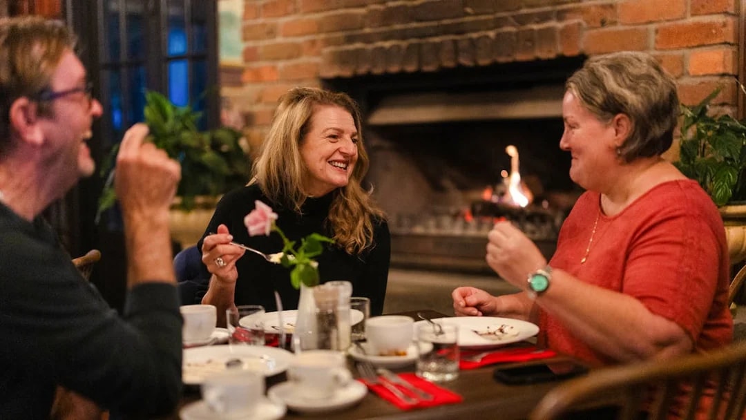 Dining by a cozy fireplace during the Evening Rainforest & Glow Worm Experience.