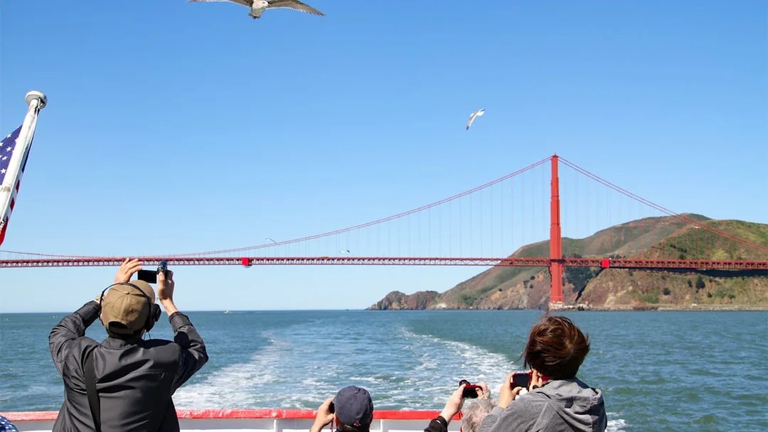 Guests photographing Golden Gate Bridge from San Francisco Bay Cruise.