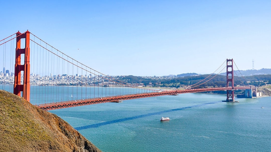 Aerial view of Golden Gate Bridge and bay cruise ship in San Francisco, USA.