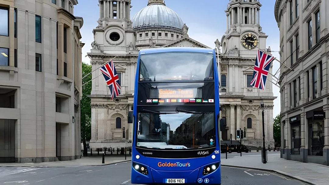 Open-top London tour bus in front of St. Paul's Cathedral.