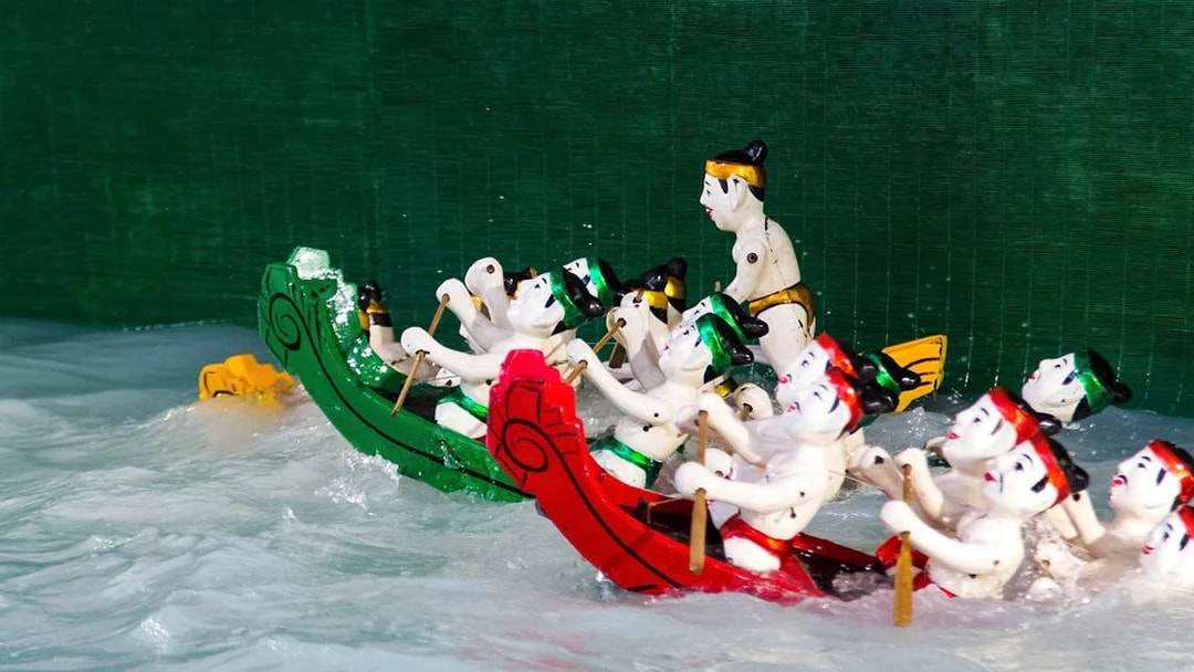 Water puppets in colorful boats performing at Golden Water Puppet Show.