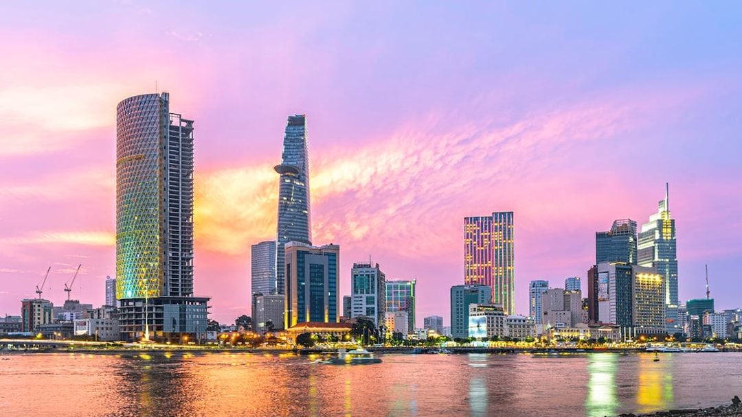 Cityscape of Ho Chi Minh City with Saigon River at sunset.